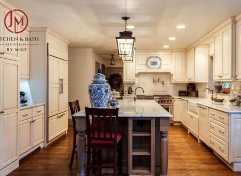 full view of country kitchen remodel with large island, custom distressed cabinets and copper finishes JM Kitchen & Bath Design