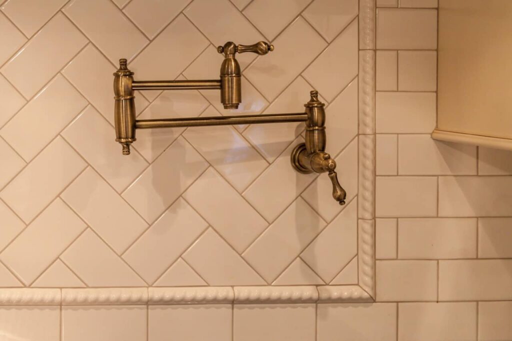 close up of copper pot filler and subway tile in newly remodeled kitchen JM Kitchen & Bath Design