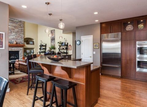 remodeled modern kitchen featuring large cabinets with longer hardware and dark wood finishes JM Kitchen & Bath Design