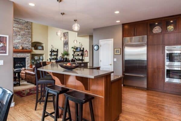 remodeled modern kitchen featuring large cabinets with longer hardware and dark wood finishes JM Kitchen & Bath Design