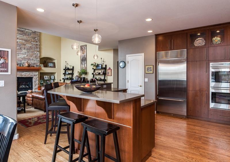 remodeled modern kitchen featuring large cabinets with longer hardware and dark wood finishes JM Kitchen & Bath Design