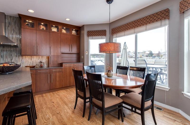 remodeled kitchen with seating area for 6 dark wood and gray accents JM Kitchen & Bath Design