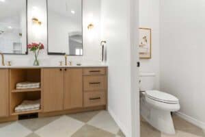 remodeled bathroom offers dual sinks and separate door to toilet JM Kitchen & Bath Design