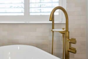 new tub has matte brass fixtures JM Kitchen & Bath Design