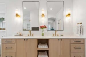 view of dual sinks, cabinetry, and matte brass finishes in newly remodeled bathroom JM Kitchen & Bath Design