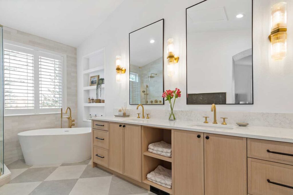 light gray and matte brass finishes highlight remodeled bathroom JM Kitchen & Bath Design