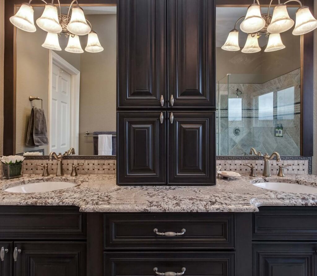 bathroom with dual vanity and linen storage in the middle are features of newly remodeled bathroom JM Kitchen & Bath Design