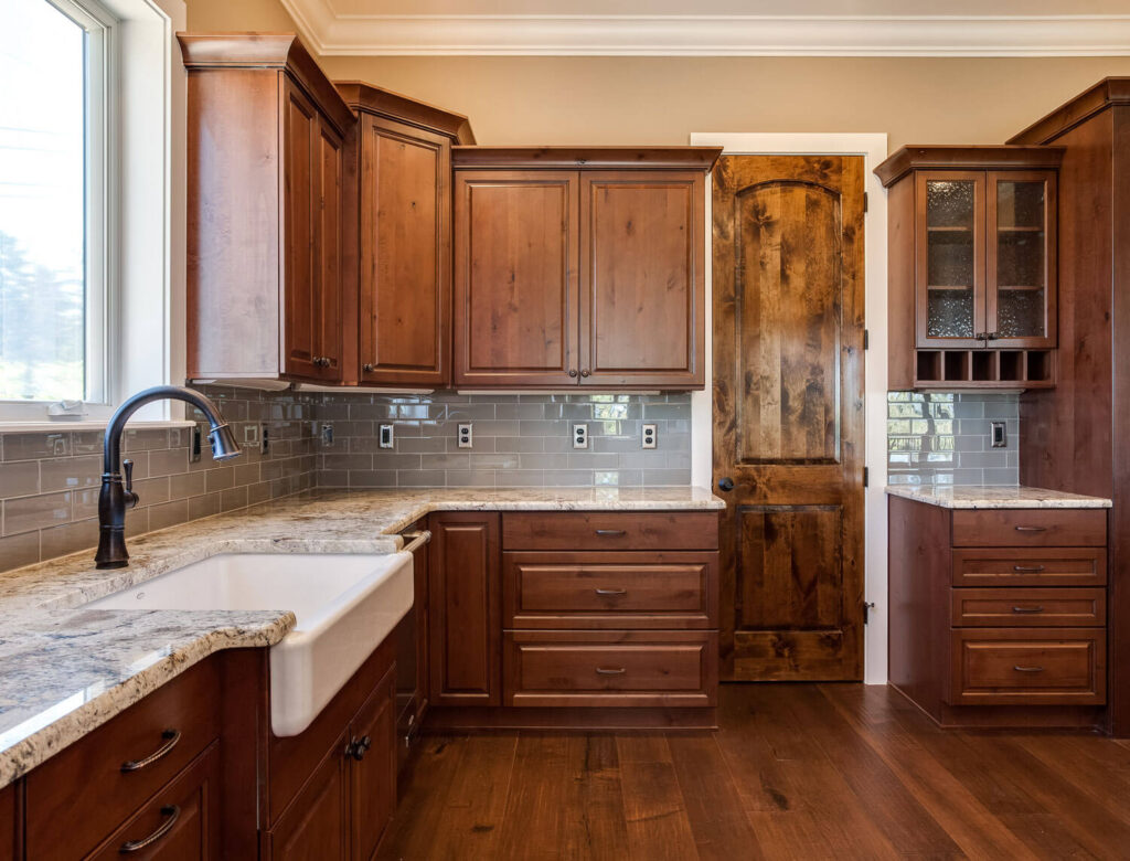 JM Kitchen & Bath Design remodeled kitchen with apron sink and darker cabinets JM Kitchen & Bath Design