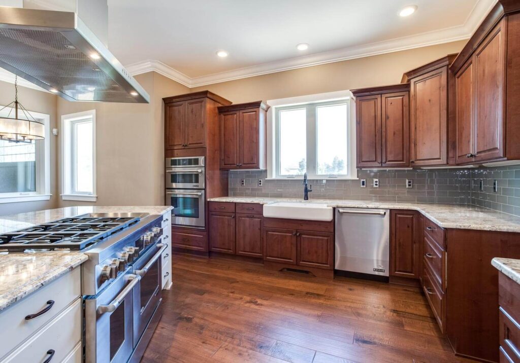 kitchen remodel with new stove, several ovens, and dark wood cabinets JM Kitchen & Bath Design