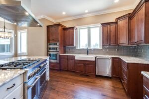 kitchen remodel with new stove, several ovens, and dark wood cabinets JM Kitchen & Bath Design