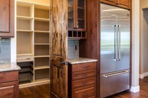 custom kitchen remodel features a walk in pantry with lots of shelf space JM Kitchen & Bath Design