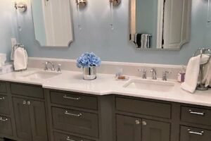 remodeled bathroom features dual sinks and new cabinets JM Kitchen & Bath Design