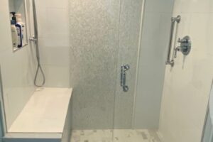 updated shower features seat and shelf for shampoo JM Kitchen & Bath Design