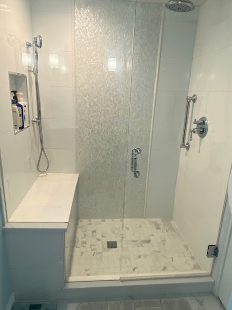 updated shower features seat and shelf for shampoo JM Kitchen & Bath Design