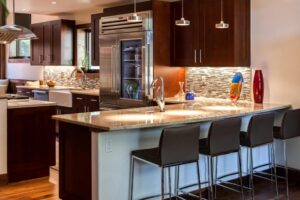 remodeled kitchen from JM Kitchen & Bath Design featuring new bar, countertops, cabinets, appliances and lighting