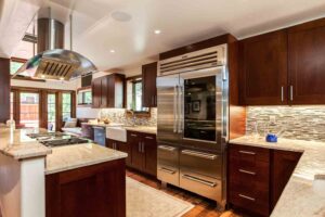 large refrigerator freezer, new granite countertops, and modern backsplash JM Kitchen & Bath Design