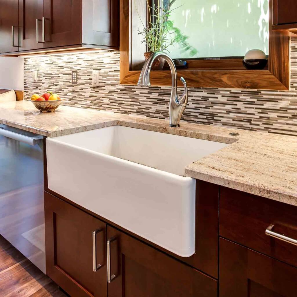 apron sink and new backsplash are a few of the remodel features in this new kitchen JM Kitchen & Bath Design