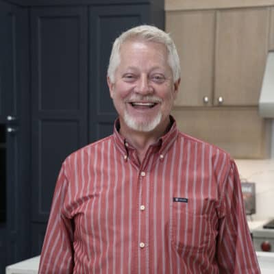 employee with JM Kitchen & Bath Design smiling in showroom