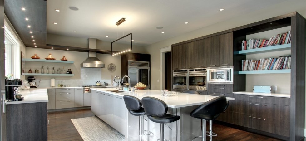 Black wood cabinet kitchen with island and stove hood