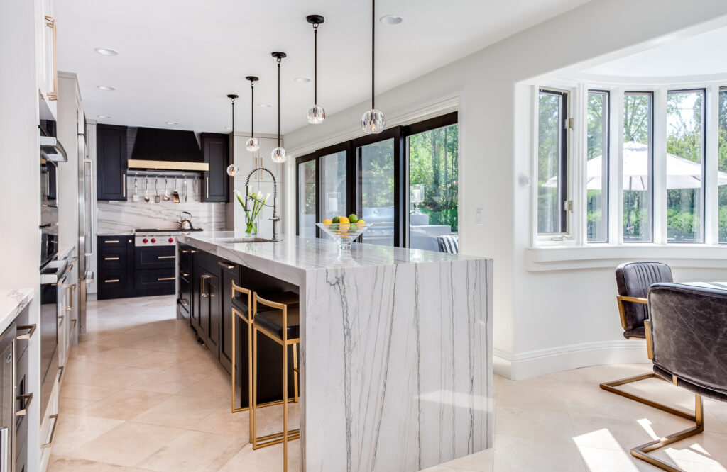 Contemporary Black Painted Cabinets with Gold Hardware in a white kitchen