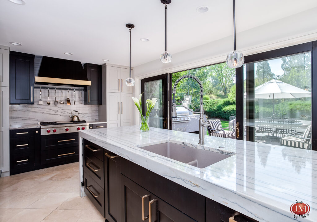 Views of the outdoor space surrounding this home are featured thorough the large glass windows from the greenwood village kitchen. 