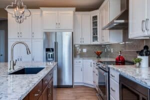 White cabinet kitchen with grey tile backsplash JM Kitchen & Bath Design