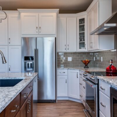 White cabinet kitchen with grey tile backsplash JM Kitchen & Bath Design