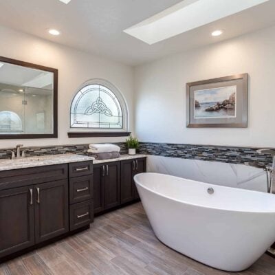 modern master bathroom design project features skylights, large tub, and cabinet storage JM Kitchen & Bath Design