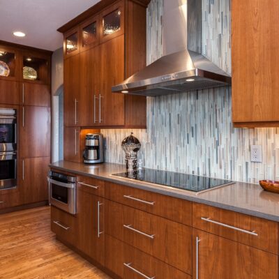 Natural wood cabinets with glass tile backsplash JM Kitchen & Bath Design