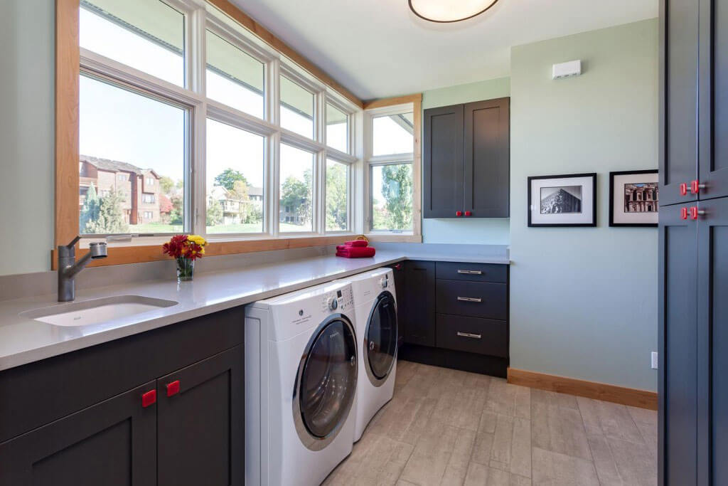 remodeled / updated laundry room featuring plenty of storage with red square hardware on cabinets