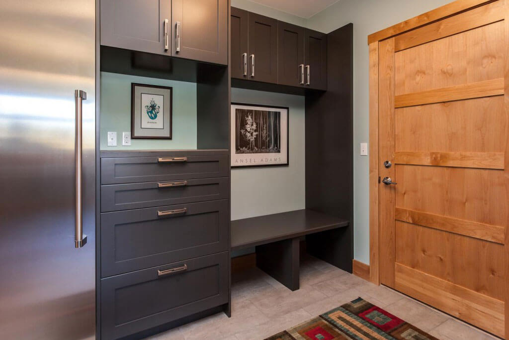 laundry room / mud room from JM Kitchen & Bath Design with storage space, cabinet space, and large refrigerator