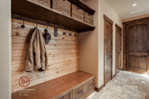 JM Kitchen & Bath Design mudroom remodel with beautiful wood finishes, floor tile, and hooks and baskets for personal items