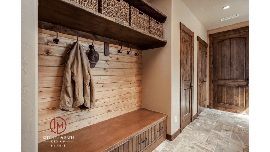 JM Kitchen & Bath Design mudroom remodel with beautiful wood finishes, floor tile, and hooks and baskets for personal items