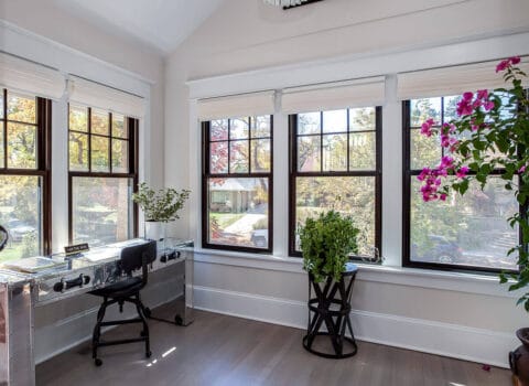 study remodel from JM Kitchen & Bath Design with modern, steel desk and five windows bringing in natural light