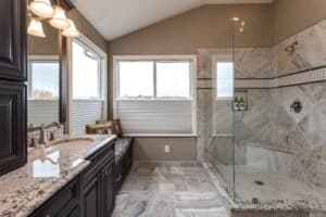 Master bath with granite vanity and glass shower JM Kitchen & Bath Design