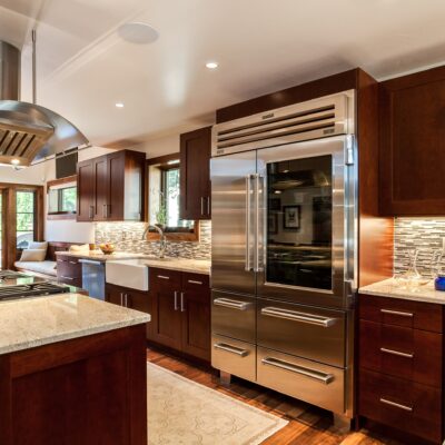 Dark wood cabinet kitchen with large stainless steel refrigerator JM Kitchen & Bath Design