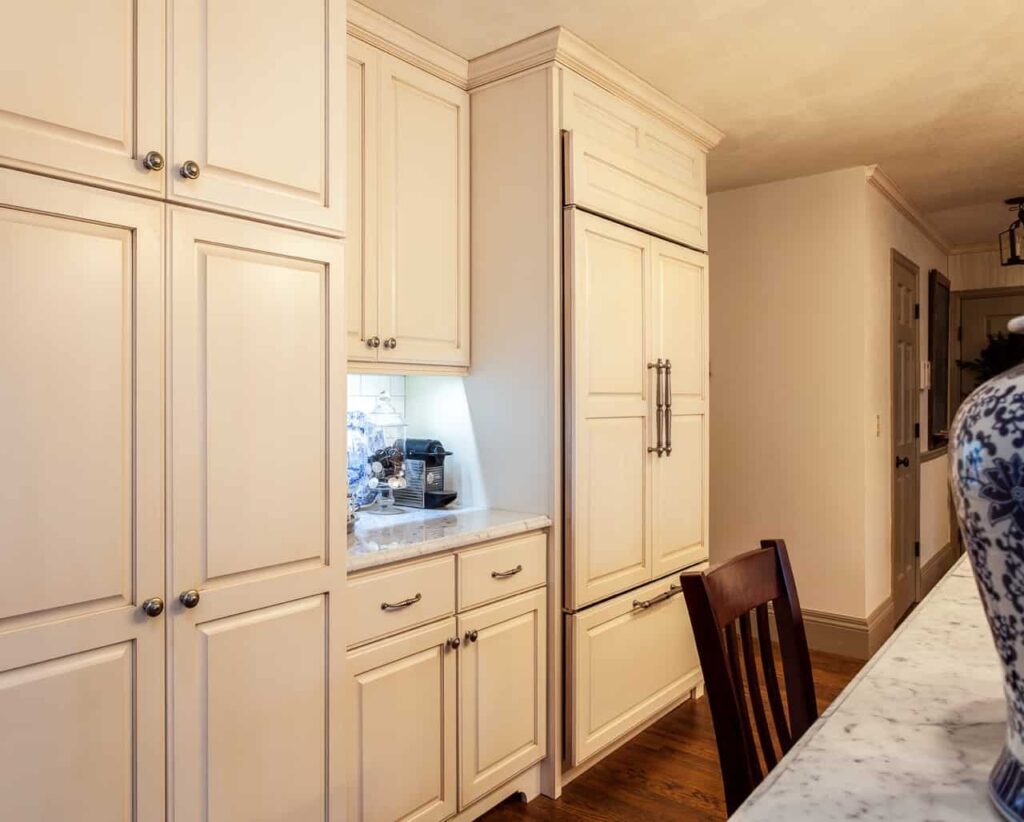 Spectacular 42" Sub Zero wood paneled Refrigerator sets off this wall of storage for this Traditional European French Country Kitchen