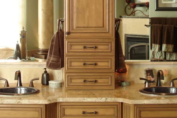 bathroom remodel features traditional finishes and cabinet storage between two sinks JM Kitchen & Bath Design