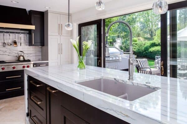 kitchen with white countertops and brand new stove and large sliding doors to patio JM Kitchen & Bath Design