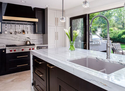 kitchen with white countertops and brand new stove and large sliding doors to patio JM Kitchen & Bath Design