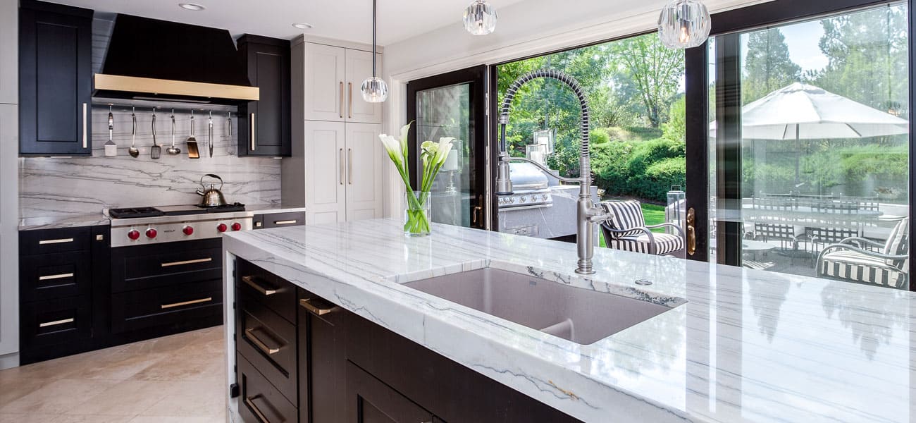 kitchen with white countertops and brand new stove and large sliding doors to patio JM Kitchen & Bath Design