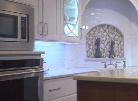 kitchen remodel features shiny white tile and neutral accents JM Kitchen & Bath Design