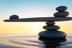 Seesaw Stack of Stones in water at sunset JM Kitchen & Bath Design