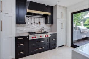 Black Stove top with two tone stove hood JM Kitchen & Bath Design