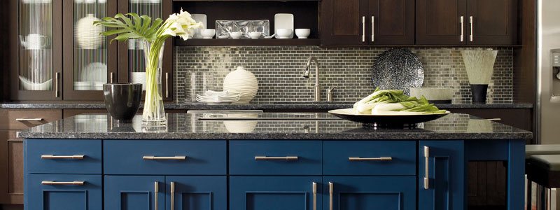 Dark blue cabinets with granite countertop and silver backsplash