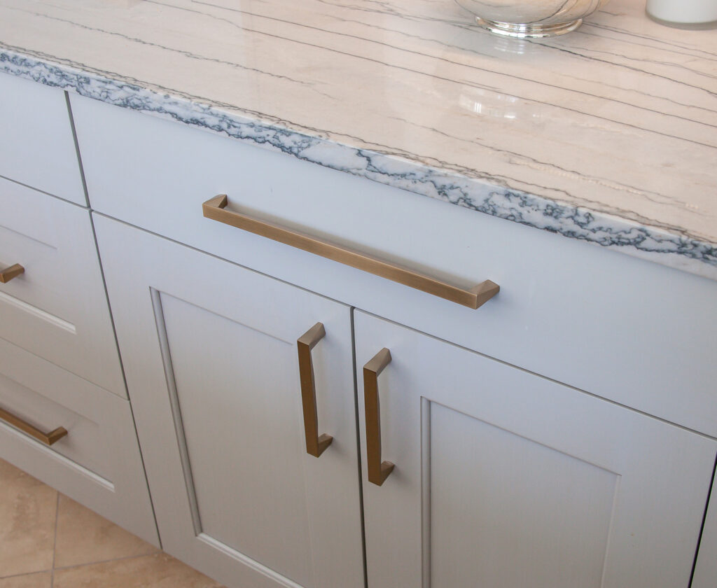 Brass hardware on grey transitional cabinets