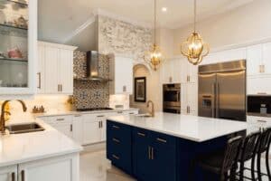 kitchen renovation uses latest trends with dark brass hardware and complimentary tile behind stove JM Kitchen & Bath Design