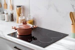 cooktop with copper colored pot JM Kitchen & Bath Design