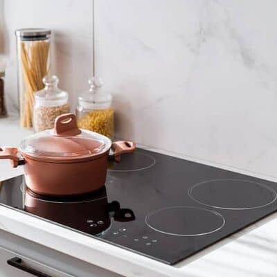 cooktop with copper colored pot JM Kitchen & Bath Design