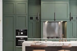 kitchen remodel features moss green cabinetry and dual island/bar JM Kitchen & Bath Design